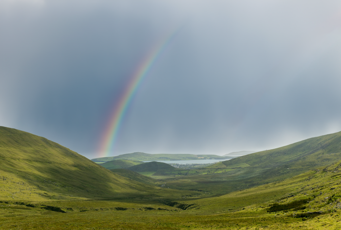 Rainbow over green mountains